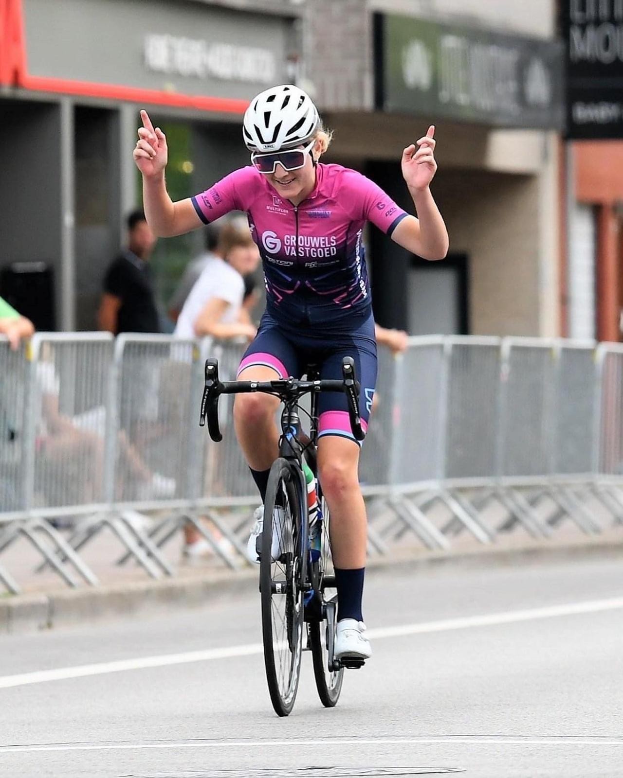 Ellie Parry celebrating on her bike at a race